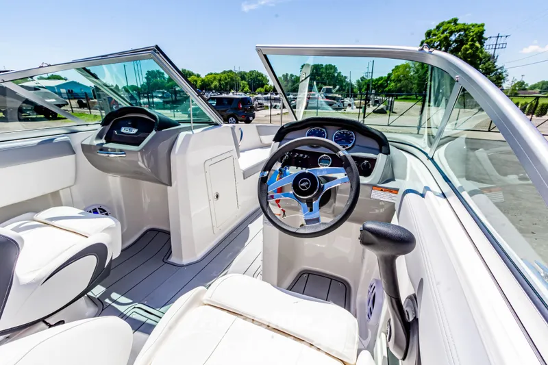 Slide: The Image of 2024 Chaparral 19 SSi OB boat interior with steering wheel and dashboard, showcasing modern design. - 19