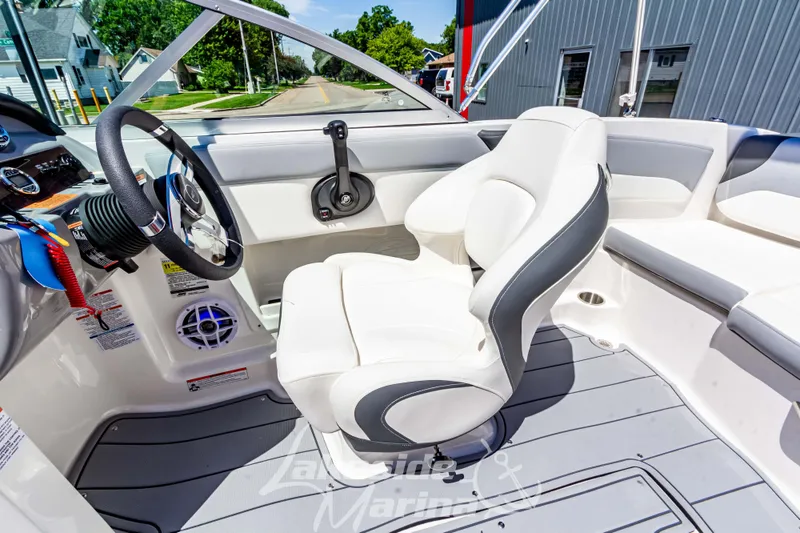 Slide: The Image of 2024 Chaparral 19 SSi OB boat interior with white seating and steering wheel. - 21