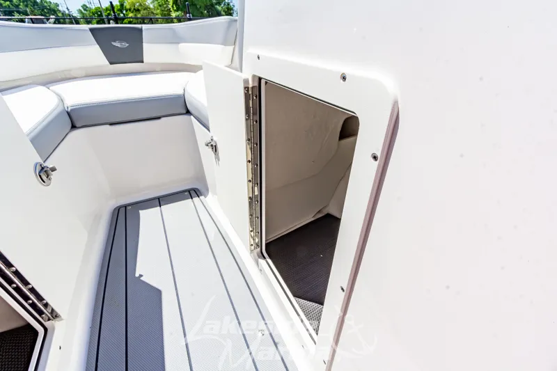 Slide: The Image of 2024 Chaparral 19 SSi OB boat interior storage compartment with open door. - 27