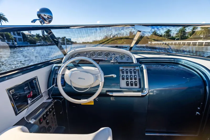 Slide: The Image of Interior view of 2013 Riva 33 Aquariva boat cockpit with steering wheel and controls. - 11