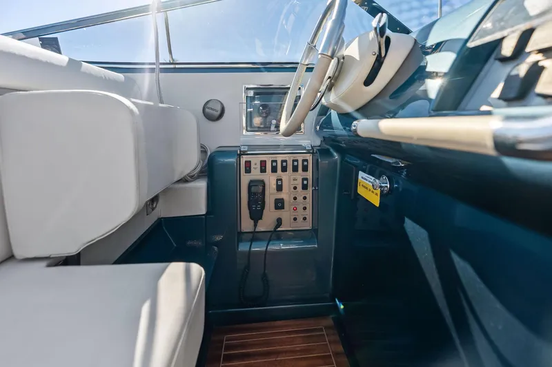 Slide: The Image of Interior of 2013 Riva 33 Aquariva boat, featuring steering wheel and control panel. - 13