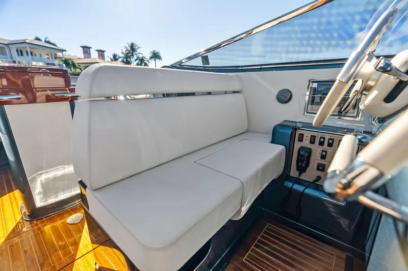 Slide: The Image of Interior of 2013 Riva 33 Aquariva boat with white seating and control panel. - 14