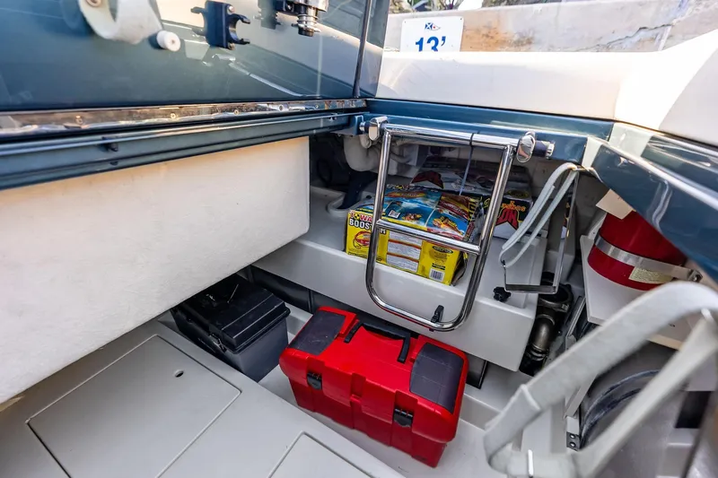 Slide: The Image of Storage compartment of 2013 Riva 33 Aquariva boat with tools and supplies. - 18
