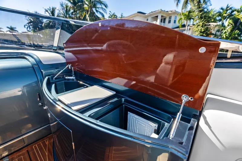 Slide: The Image of 2013 Riva 33 Aquariva boat interior with open wooden compartment, showcasing sleek design. - 8