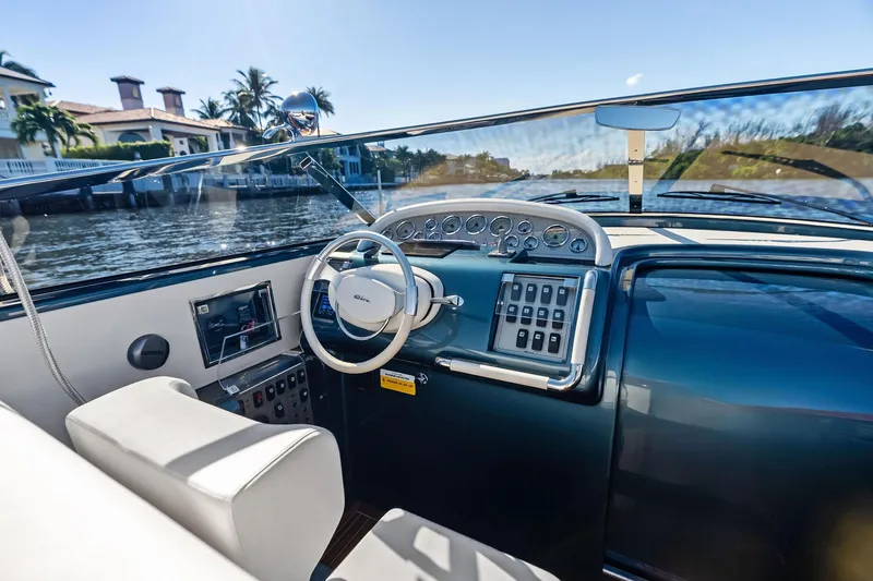 Slide: The Image of Interior view of a 2013 Riva 33 Aquariva yacht, showcasing the sleek dashboard and steering wheel. - 10