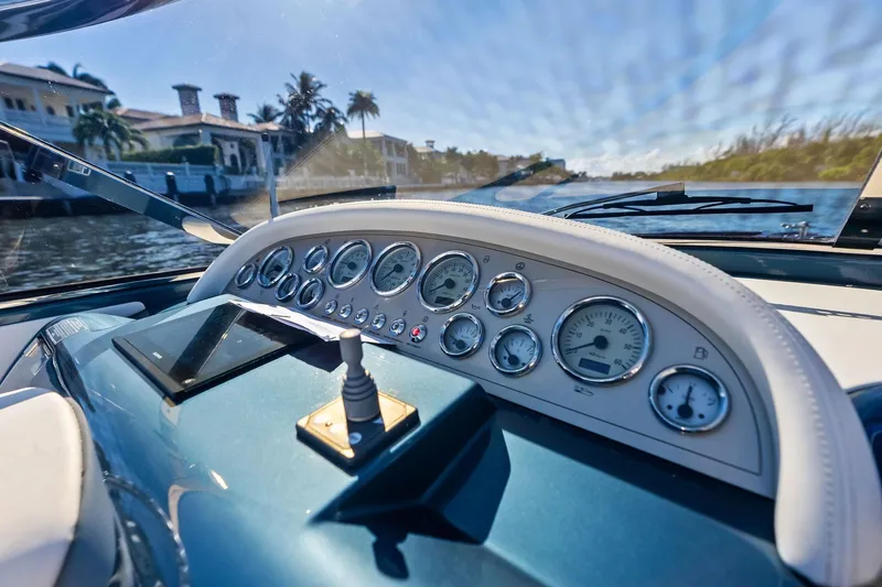 Slide: The Image of Dashboard of a 2013 Riva 33 Aquariva boat with gauges and controls. - 12