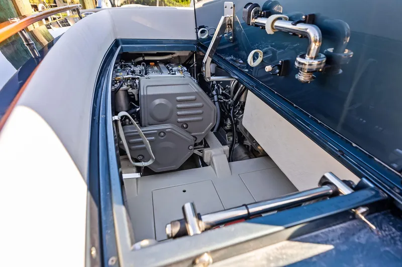 Slide: The Image of Engine compartment of 2013 Riva 33 Aquariva boat, showcasing mechanical components and sleek design. - 16