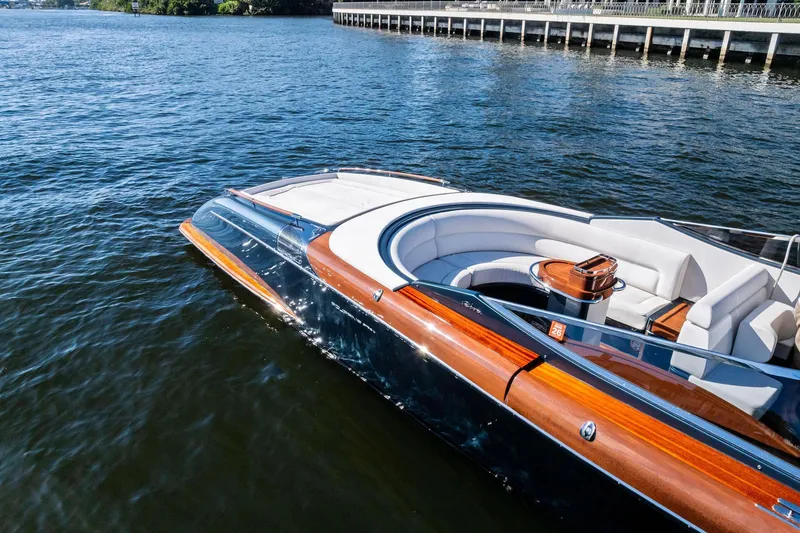 Slide: The Image of 2013 Riva 33 Aquariva luxury boat with sleek design on calm water. - 5
