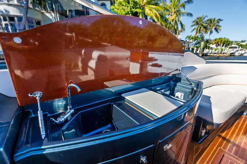 Slide: The Image of Luxurious 2013 Riva 33 Aquariva yacht interior with sleek kitchenette and elegant wood finish. - 9