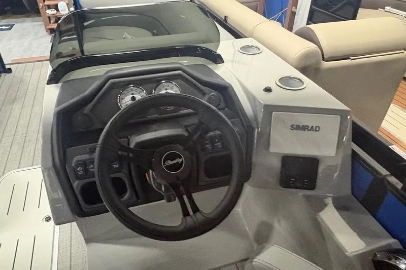 Slide: The Image of 2026 Bentley Pontoons Legacy 223 Navigator dashboard with steering wheel and Simrad display. - 4