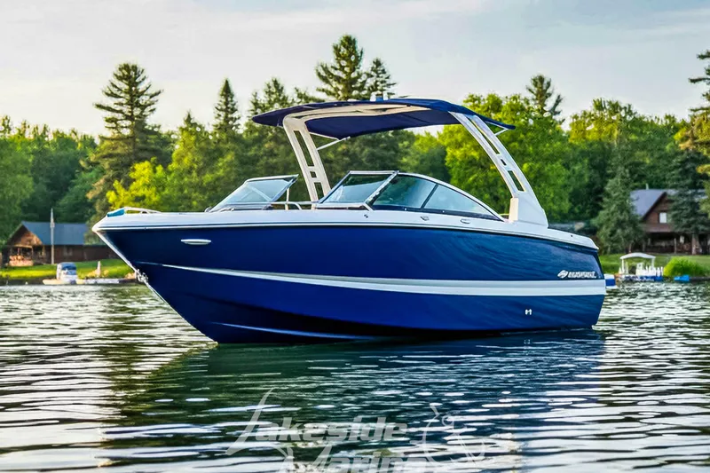 The Image of 2024 Chaparral 247 SSX boat on a serene lake with lush green trees. - 0