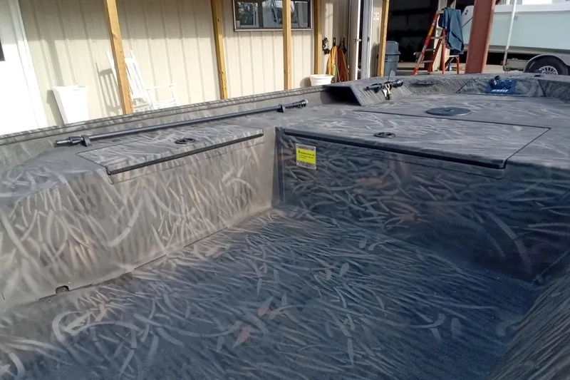 Slide: The Image of 2026 Alweld 1552 Invader boat interior with camo pattern and storage compartments. - 10