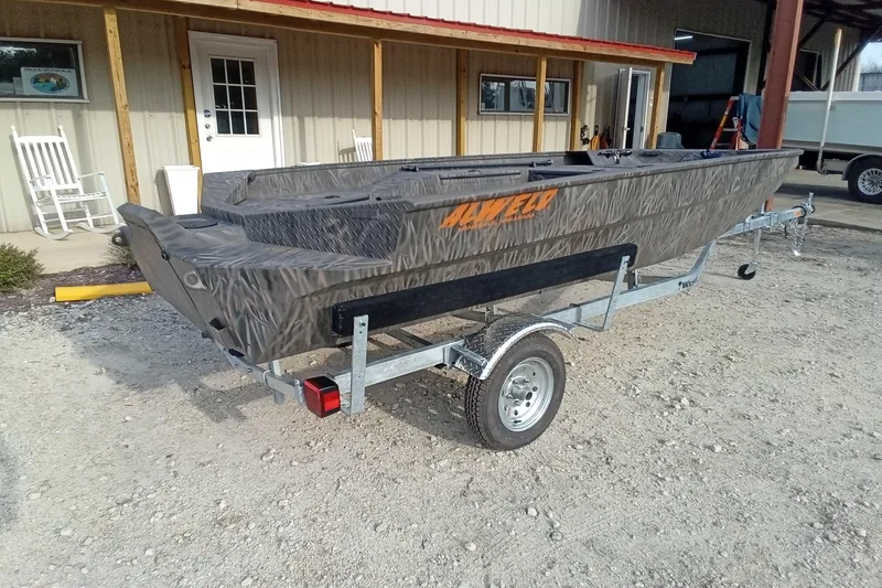 Slide: The Image of 2026 Alweld 1552 Invader boat on trailer, parked outside a building. - 11