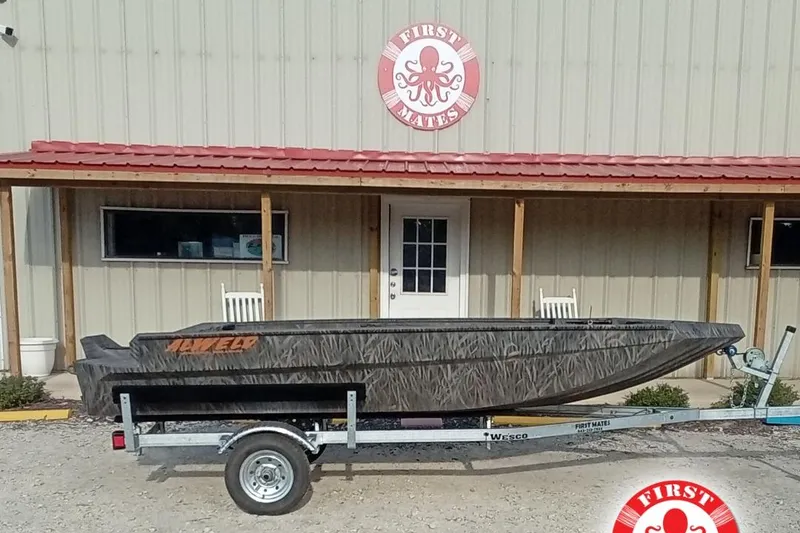 The Image of 2026 Alweld 1552 Invader boat on trailer outside First Mates store. - 2
