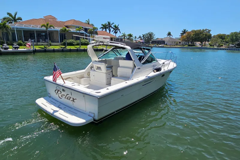 Slide: The Image of 2001 Tiara Yachts 3100 Open boat on water, rear view with American flag. - 1