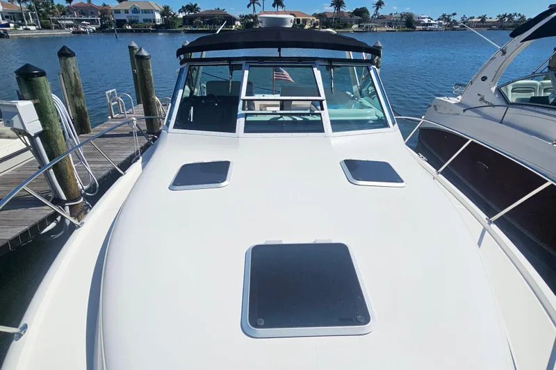 Slide: The Image of 2001 Tiara Yachts 3100 Open docked at marina, sunny day, waterfront homes in background. - 10