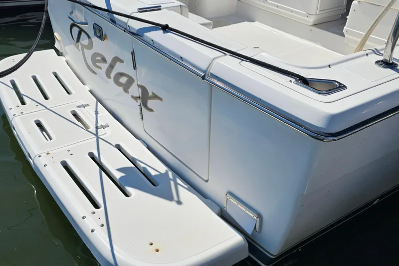 Slide: The Image of 2001 Tiara Yachts 3100 Open boat with "Relax" text on the stern platform. - 17