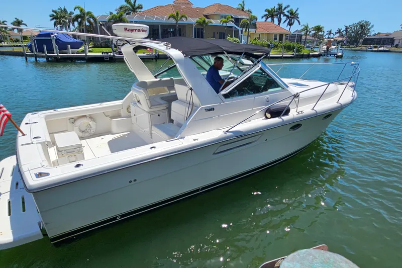 Slide: The Image of 2001 Tiara Yachts 3100 Open cruising in sunny waterfront setting. - 2