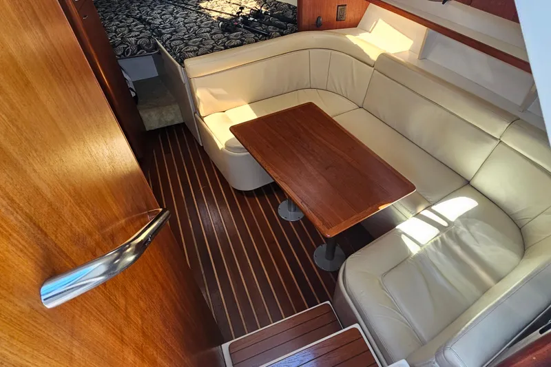 Slide: The Image of 2001 Tiara Yachts 3100 Open interior with leather seating and wooden table. - 20