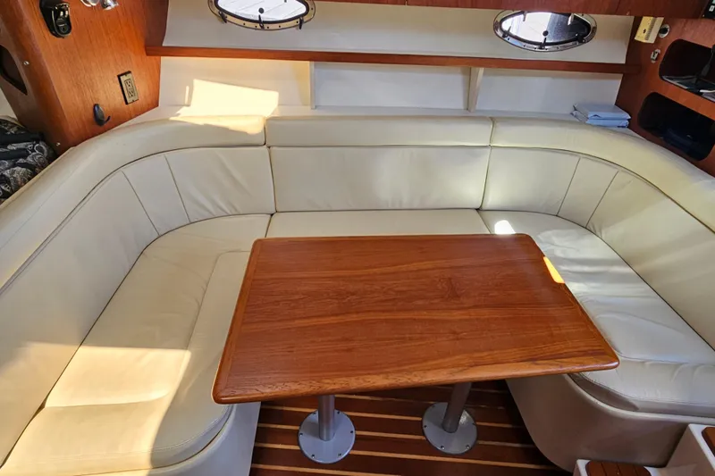 Slide: The Image of Luxurious interior of 2001 Tiara Yachts 3100 Open with leather seating and wooden table. - 26