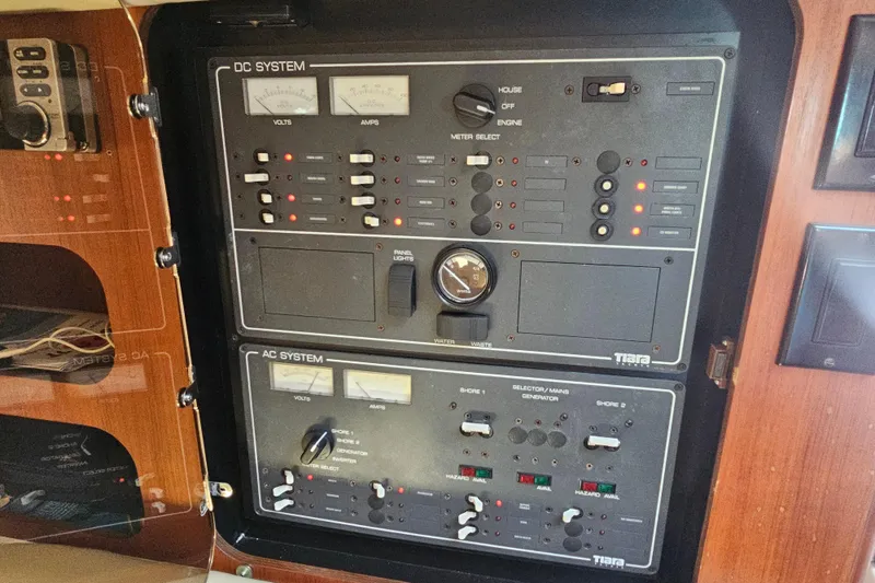 Slide: The Image of Tiara Yachts 3100 Open 2001 electrical control panel with DC and AC systems. - 27