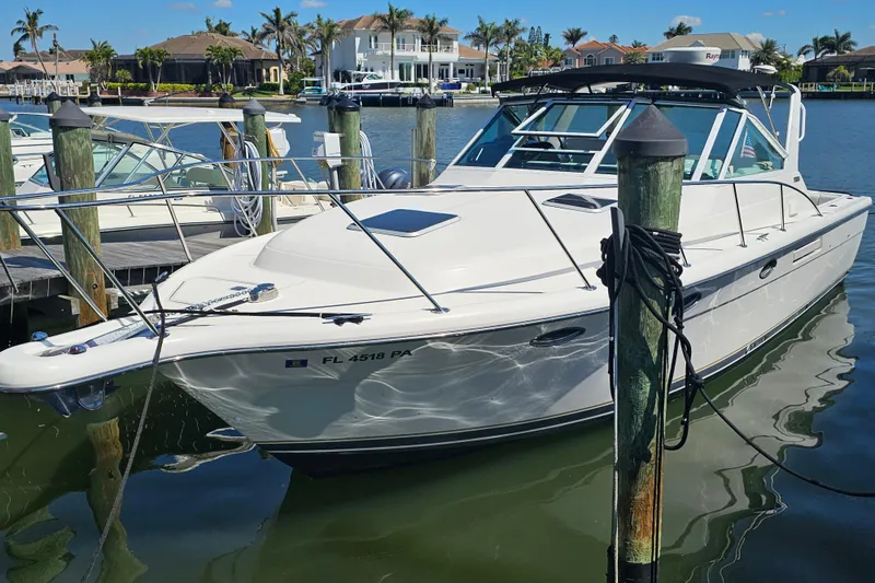 Slide: The Image of 2001 Tiara Yachts 3100 Open docked in a sunny marina setting. - 4