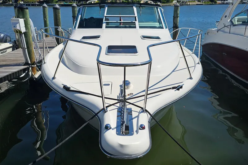 Slide: The Image of 2001 Tiara Yachts 3100 Open docked, showcasing sleek design and spacious deck. - 6