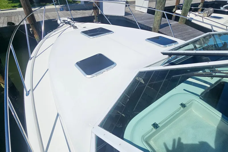Slide: The Image of 2001 Tiara Yachts 3100 Open boat deck with hatches and railing at dock. - 8