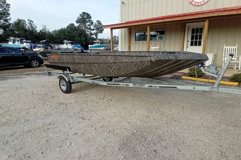 Slide: The Image of 2026 Alweld 1652 Invader boat on trailer outside a building. - 4