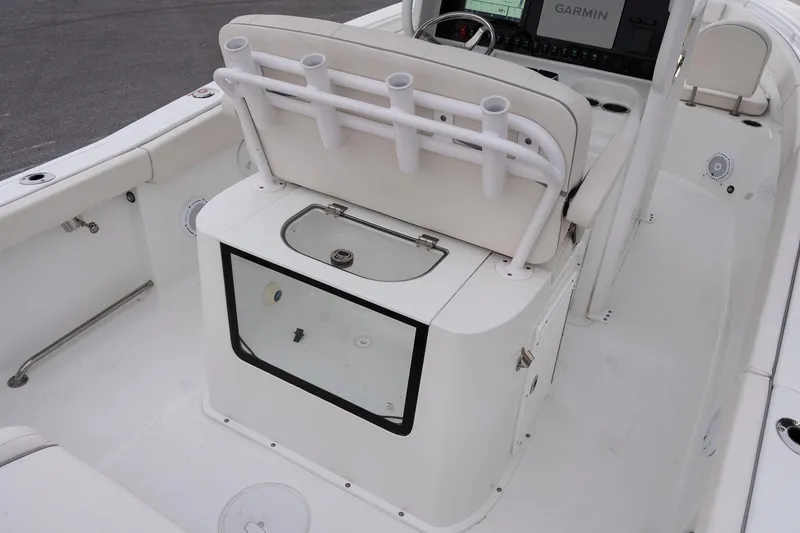 Slide: The Image of 2023 Sea Hunt Gamefish 25 boat interior with rod holders and Garmin display. - 11