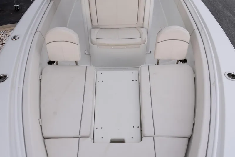 Slide: The Image of 2023 Sea Hunt Gamefish 25 boat interior with white cushioned seating. - 18