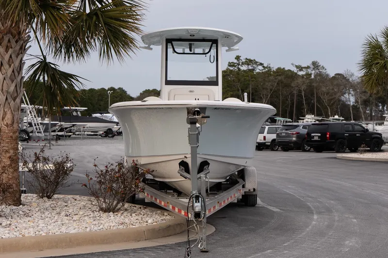 Slide: The Image of 2023 Sea Hunt Gamefish 25 boat on trailer in marina parking lot. - 3