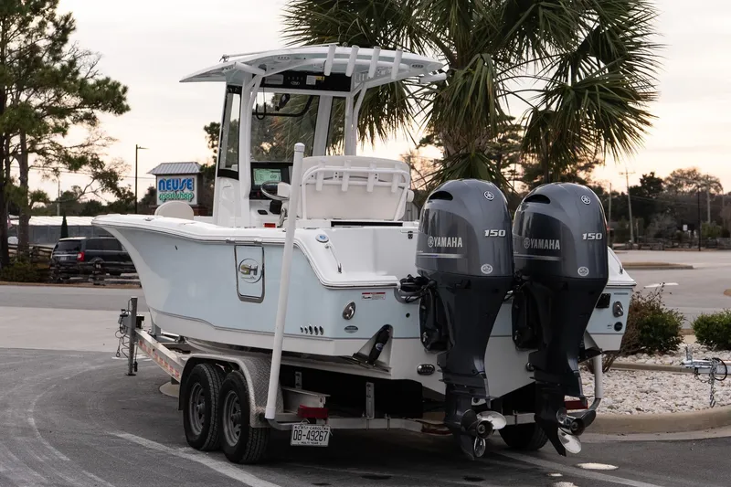 Slide: The Image of 2023 Sea Hunt Gamefish 25 boat with dual Yamaha 150 engines on a trailer. - 4