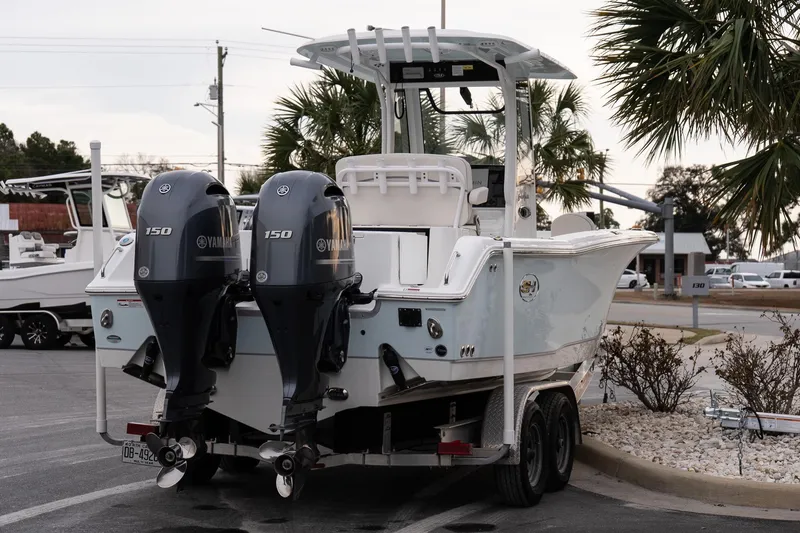 Slide: The Image of 2023 Sea Hunt Gamefish 25 boat with dual Yamaha 150 engines on a trailer. - 6
