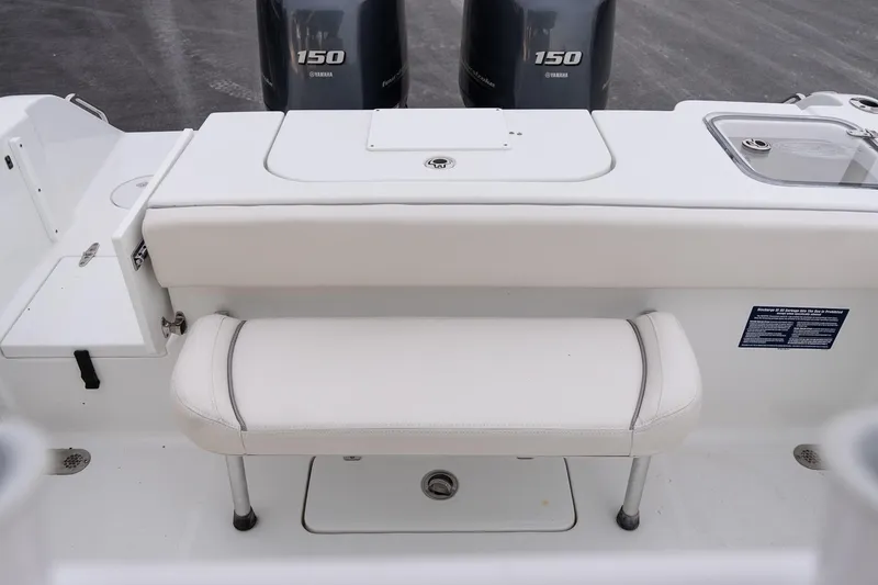 Slide: The Image of 2023 Sea Hunt Gamefish 25 boat interior with Yamaha 150 engines, featuring a white cushioned seat. - 7