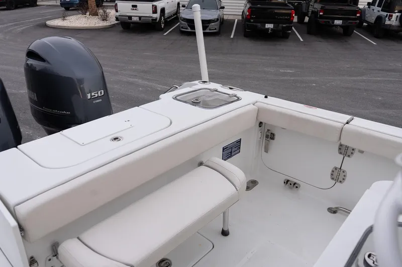 Slide: The Image of 2023 Sea Hunt Gamefish 25 boat interior with Yamaha 150 engine in parking lot. - 8