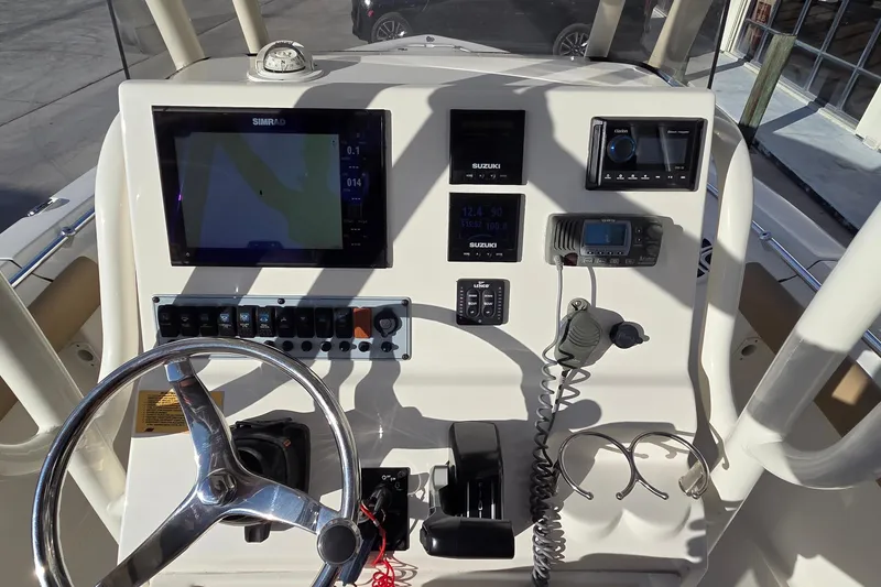 Slide: The Image of 2018 Key West 219 FS boat dashboard with navigation and control systems. - 13
