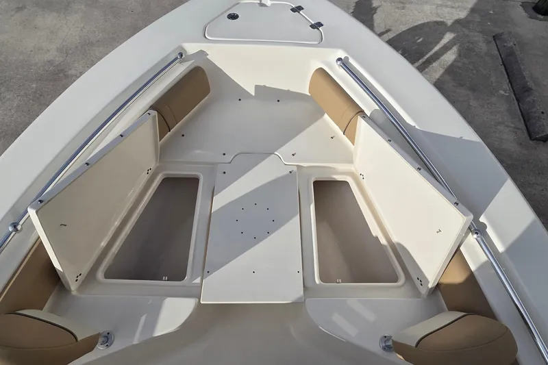 Slide: The Image of 2018 Key West 219 FS boat interior with open storage compartments and cushioned seating. - 14