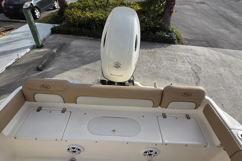 Slide: The Image of 2018 Key West 219 FS boat with Suzuki outboard motor, rear seating, and storage compartments. - 15