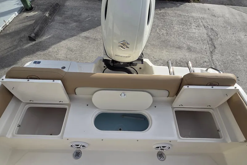 Slide: The Image of 2018 Key West 219 FS boat interior with storage compartments and Suzuki outboard motor. - 16