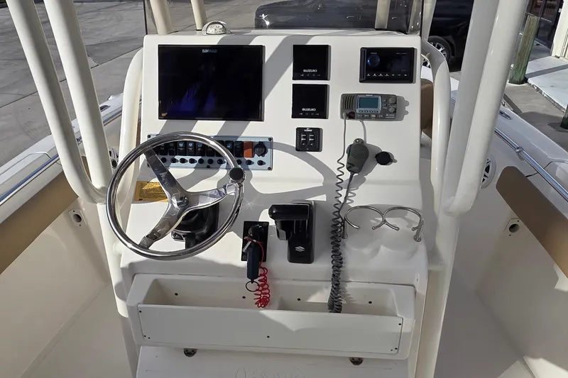 Slide: The Image of 2018 Key West 219 FS boat console with steering wheel, controls, and electronic displays. - 18