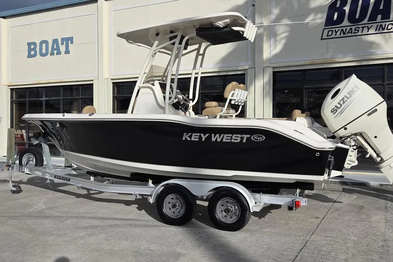 Slide: The Image of 2018 Key West 219 FS boat on trailer, displayed outside dealership. - 21