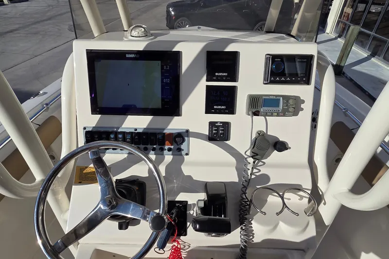 Slide: The Image of 2018 Key West 219 FS boat dashboard with steering wheel, navigation, and communication equipment. - 3
