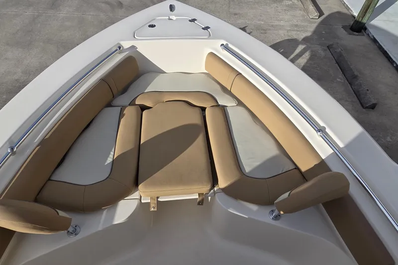 Slide: The Image of 2018 Key West 219 FS boat interior with tan cushioned seating and stainless steel rails. - 9
