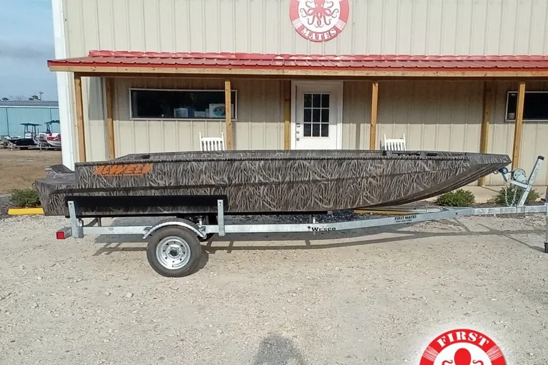 The Image of 2026 Alweld 1756 Invader boat on trailer, parked outside a building with red roof. - 2