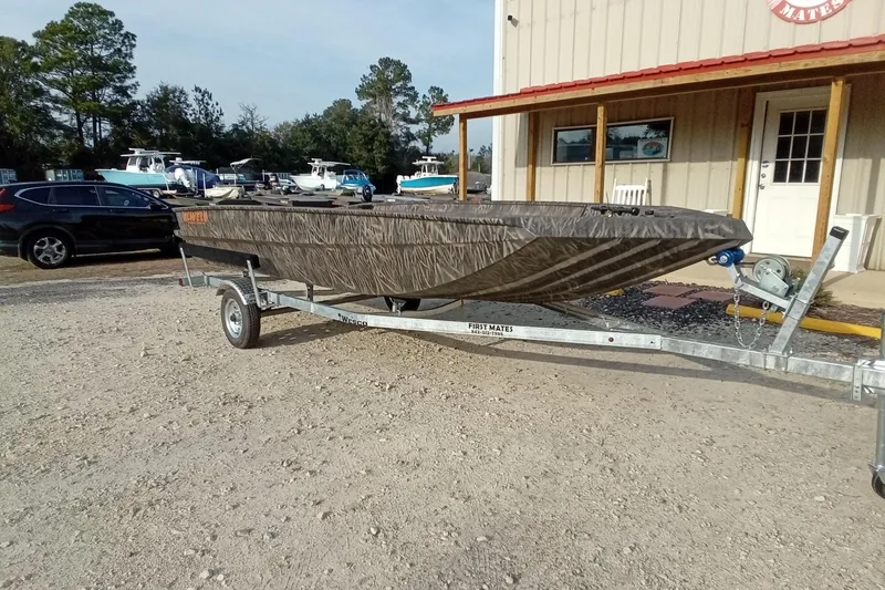 Slide: The Image of 2026 Alweld 1756 Invader boat on trailer, parked outside a building. - 4