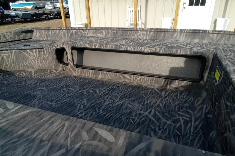 Slide: The Image of 2026 Alweld 1756 Invader boat interior with camouflage pattern and storage compartments. - 8