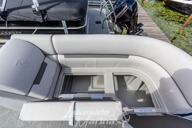 Slide: The Image of 2024 Godfrey Sweetwater 2286 SBX pontoon boat with open storage compartments and seating. - 11