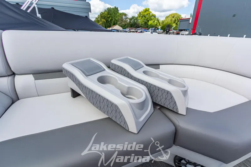 Slide: The Image of 2024 Godfrey Sweetwater 2286 SBX boat interior with cup holders and seating at Lakeside Marina. - 13