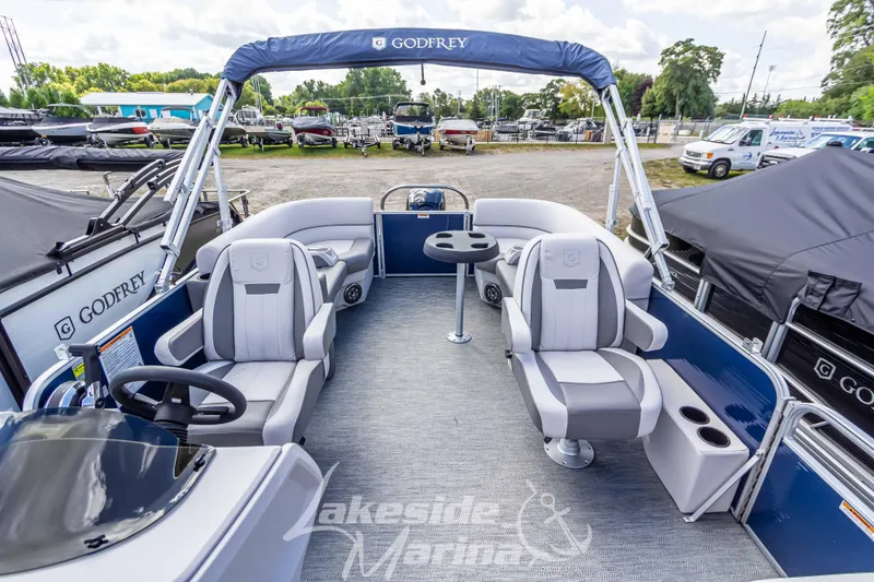 Slide: The Image of 2024 Godfrey Sweetwater 2286 SBX pontoon boat interior with seating and helm, at Lakeside Marina. - 15